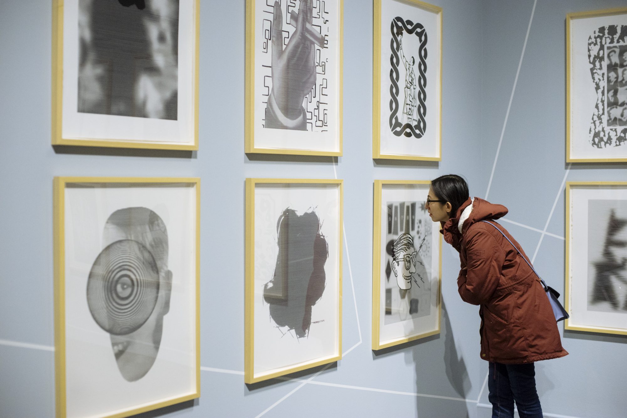 Visitors enjoy the contrasting black and white images shown in Chris Cran: At Play