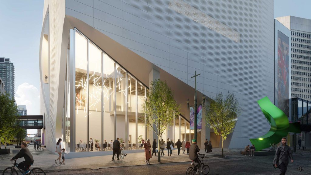 A bright, glowing entrance is encased in glass, giving a look into the future Glenbow from Stephen Avenue