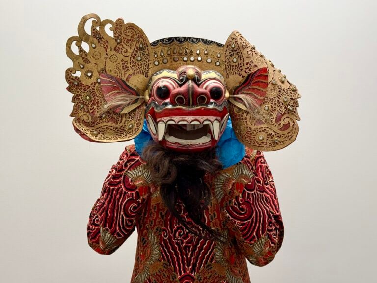 Cindy Halim holds an Indonesian mask in Glenbow’s collection.
