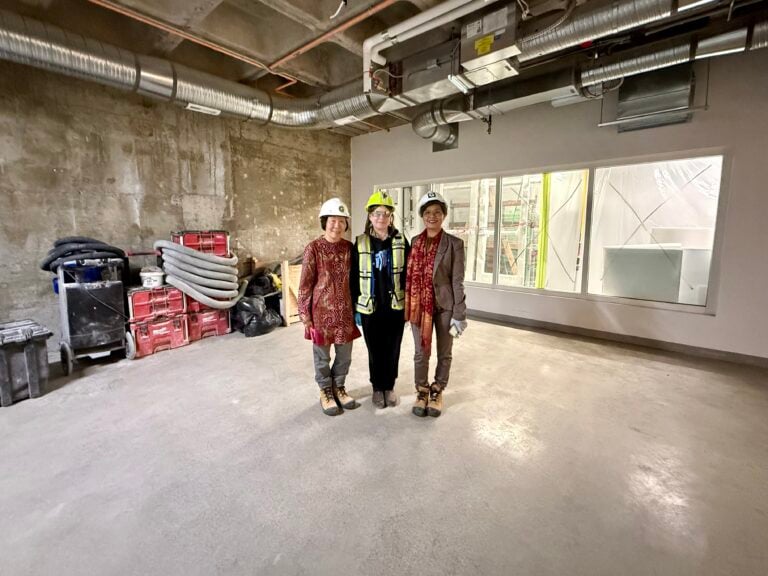 Cindy Halim, Joanne Schmidt (Glenbow’s Curator, Indigenous Studies & World Cultures), and Ratna Wynne stand in the future location of the Indonesian community display in Glenbow’s revitalized home, the JR Shaw Centre for Arts & Culture.