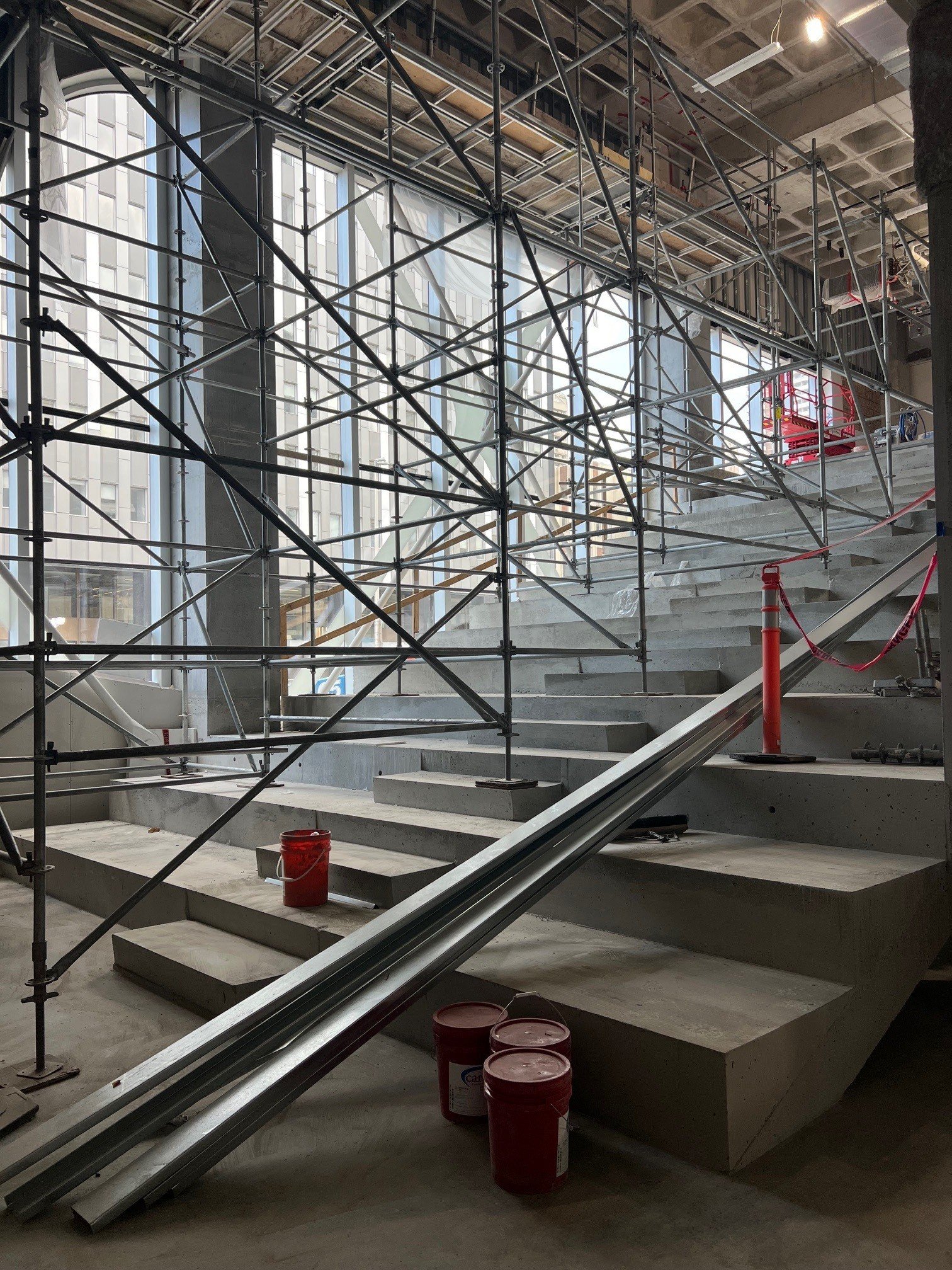 Scaffolding stands on a set of concrete risers
