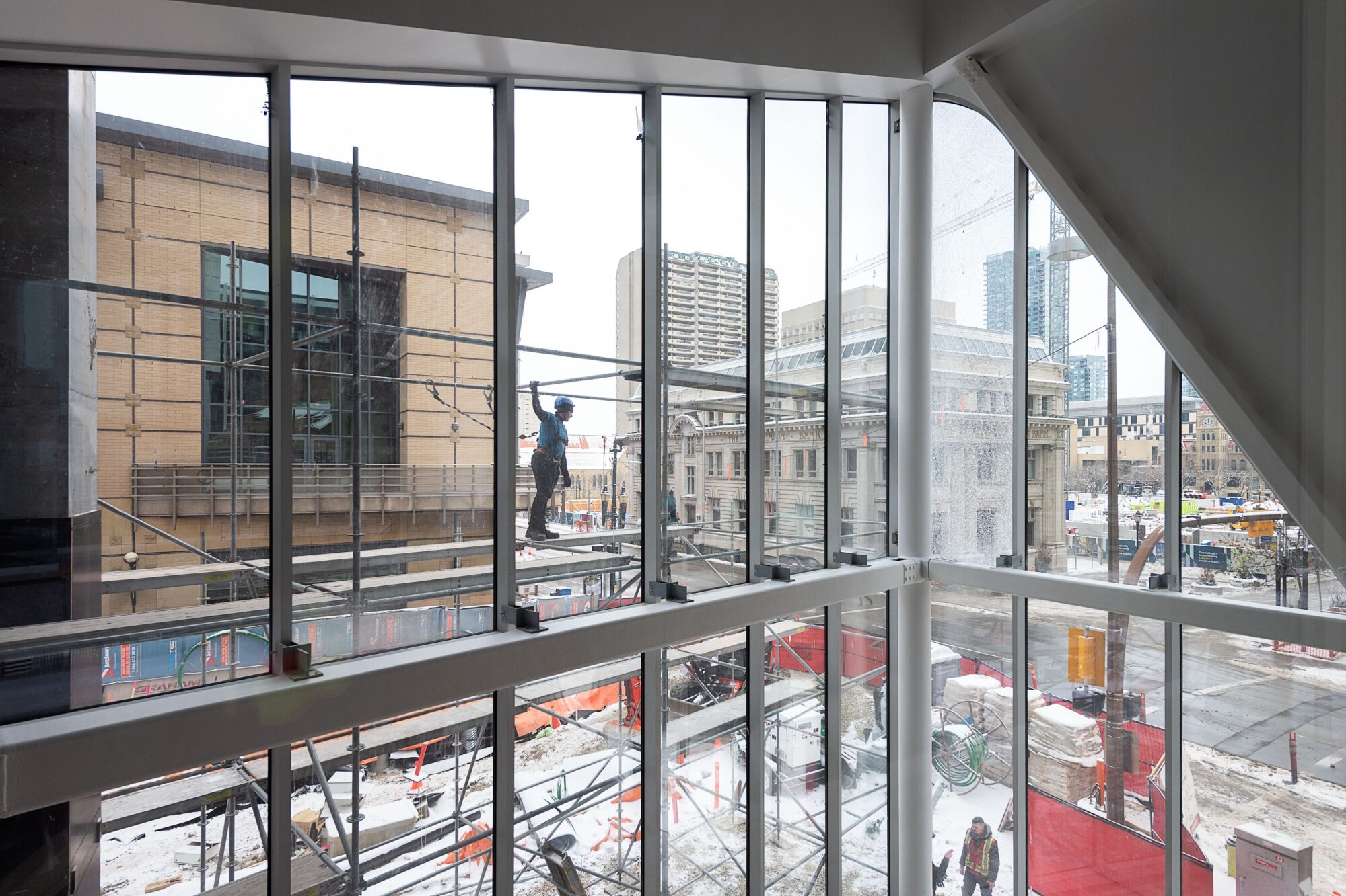 A two-storey window looking out to an urban street.