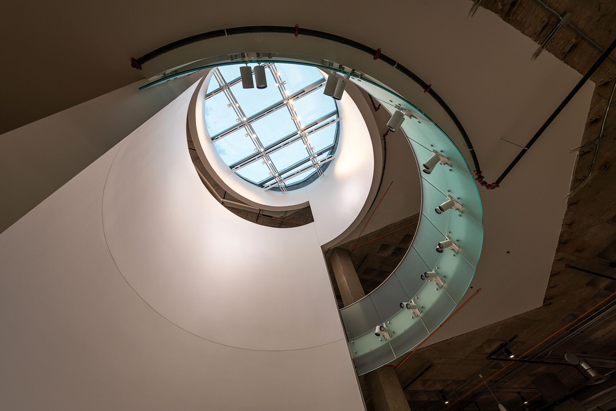 A multi-storey gallery leading toward a skylight.