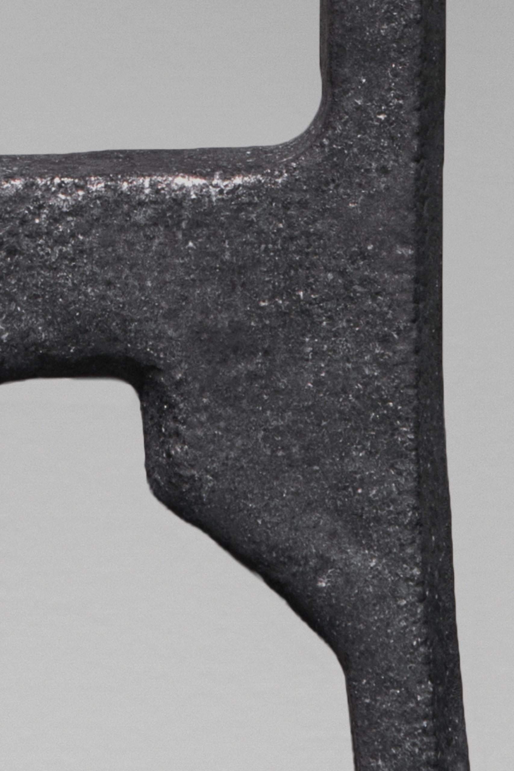 A detail image of an angular metal sculpture.