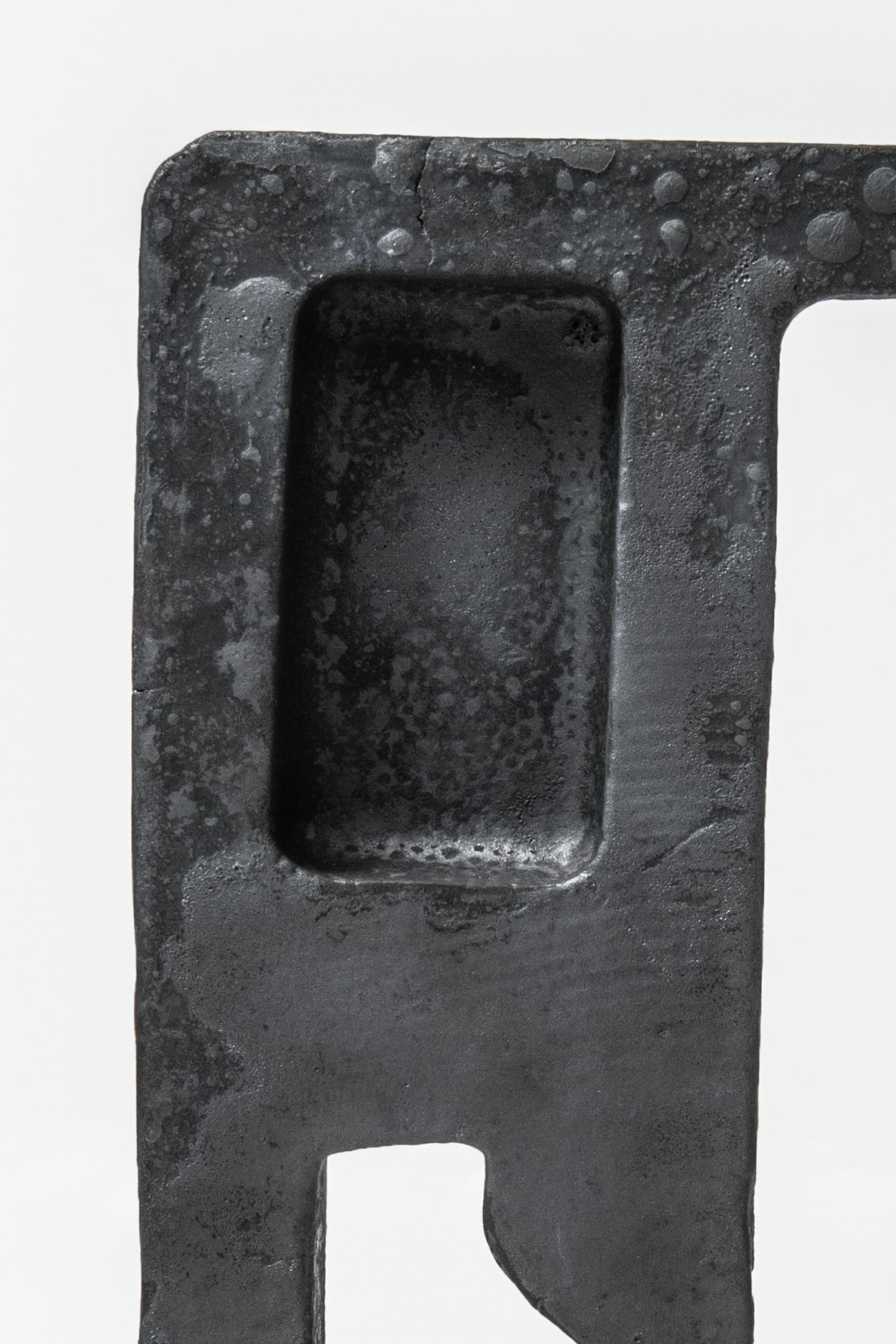 A detail image of an angular metal sculpture.